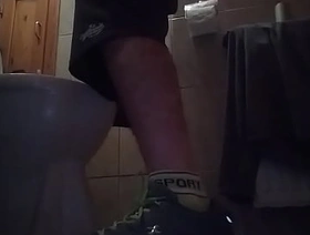 Sporty guy peeing at home